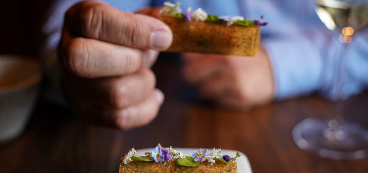 man holding dessert at 5 star Michelin star restaurant in San Francisco