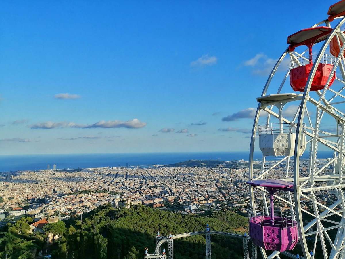 ferris wheel wish cityscape views of barcelona
