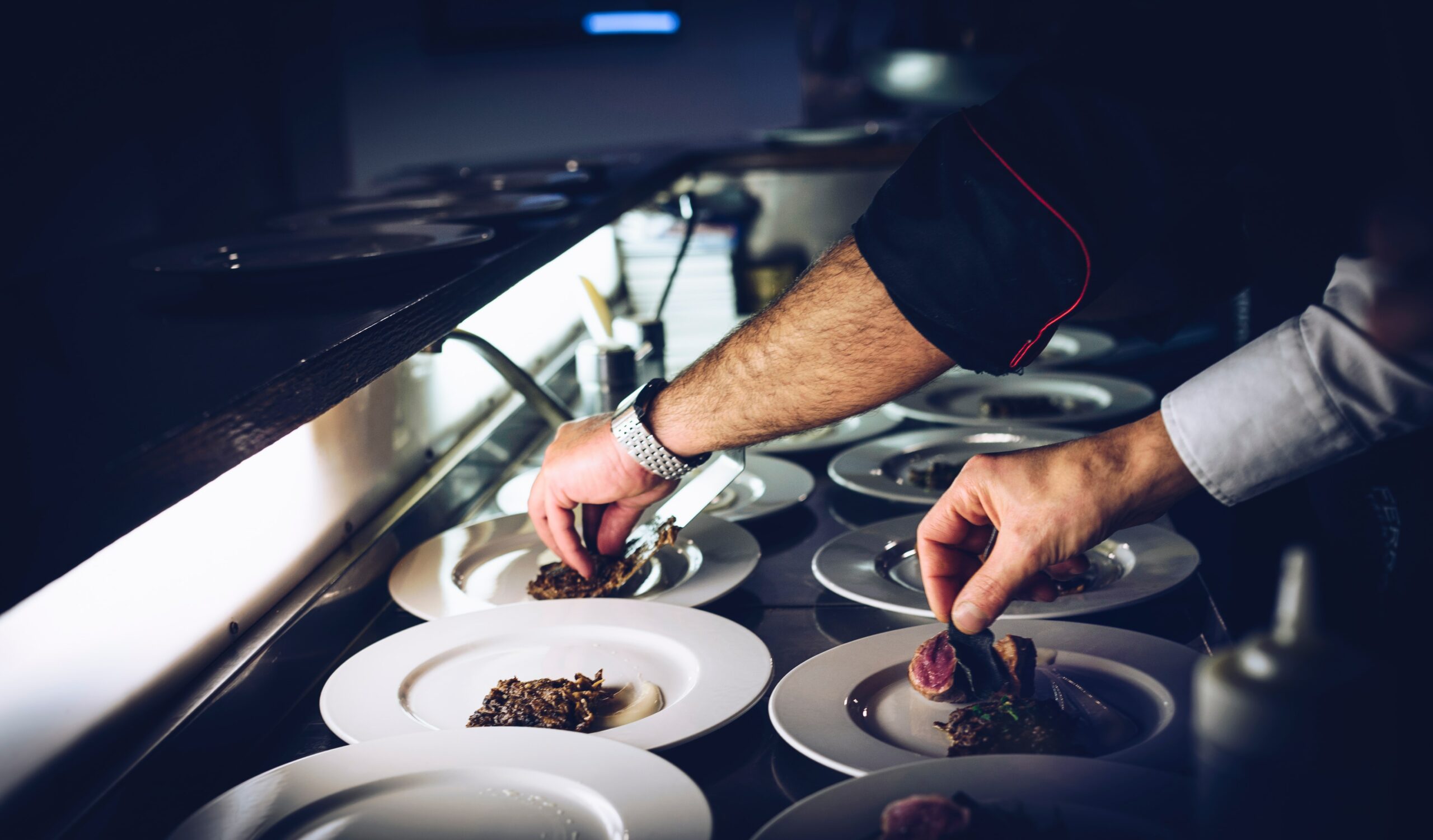 Chefs preparing plates of food