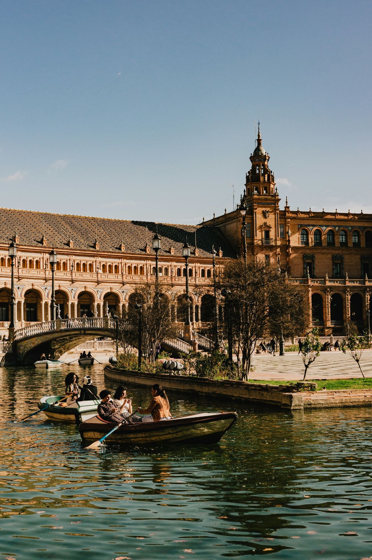 People rowing boats at Plaza Espana in Seville in November. 