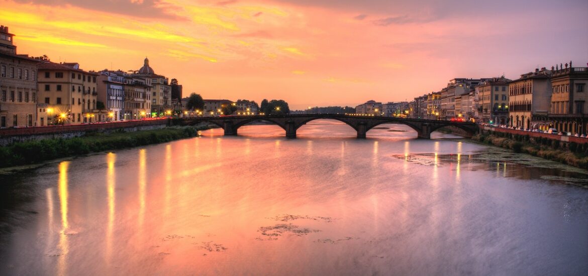 Sunset over the Arno River in Florence with a bridge in the background