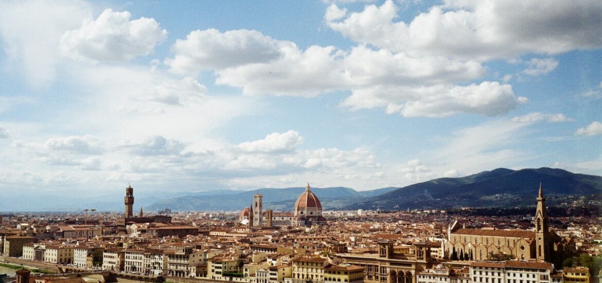 View of Florence, Italy, taken from across the river on a partly cloudy summer day