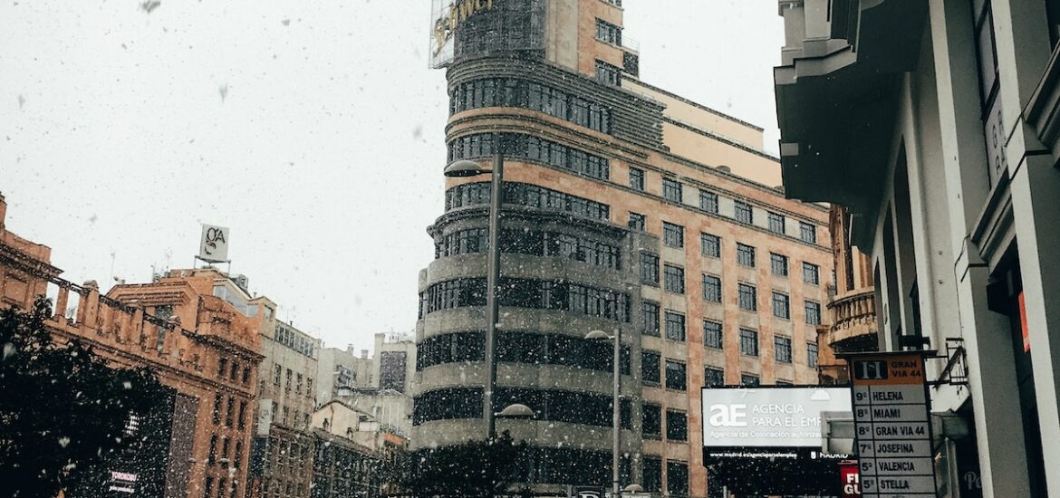 People walking with umbrellas on a busy city street.