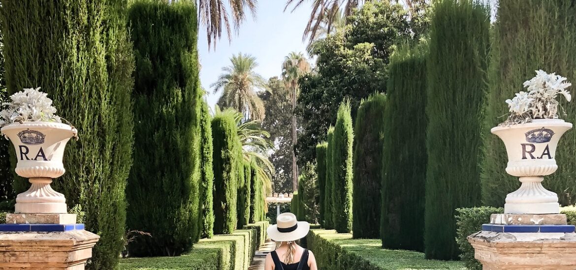 Woman strolling between columns at a park on a sunny summer day in southern spain