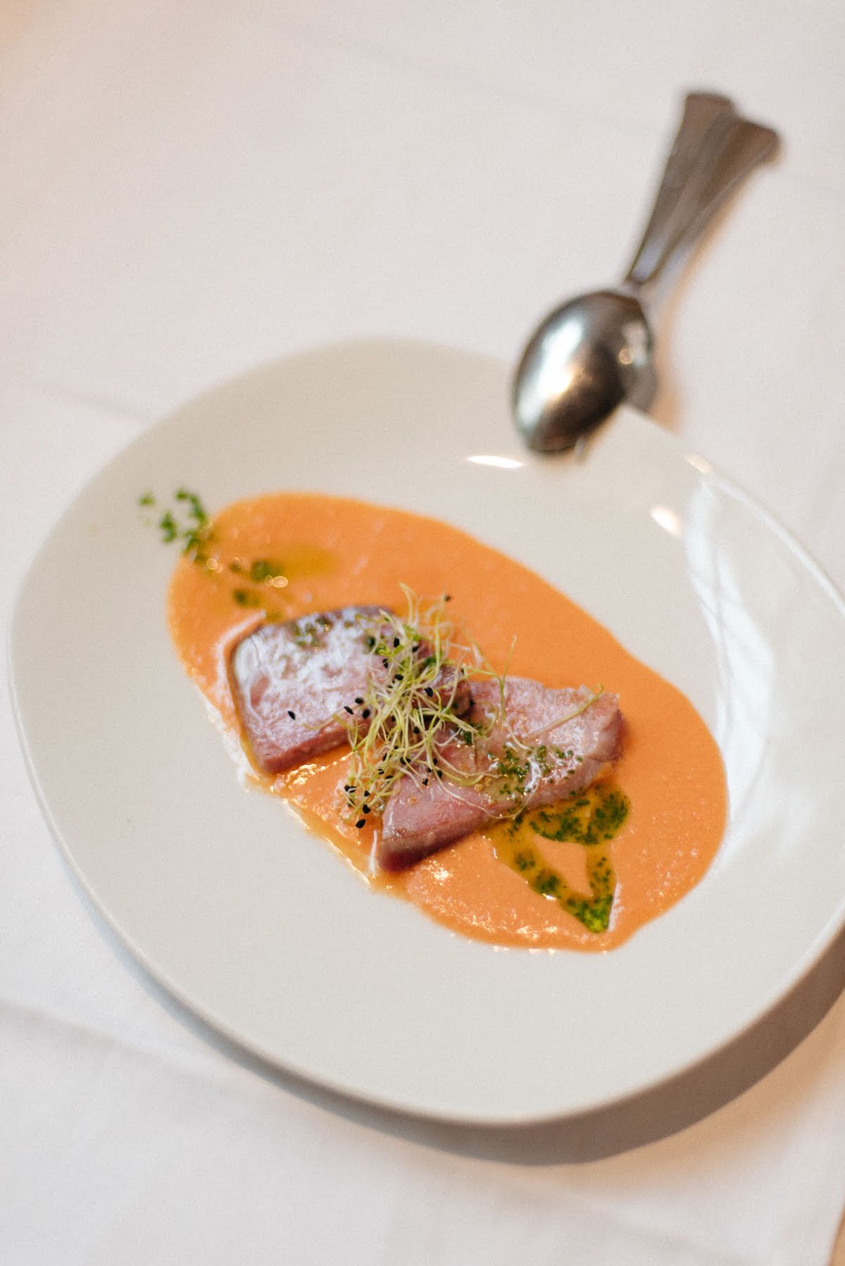 Grilled tuna on a bed of chilled tomato soup.