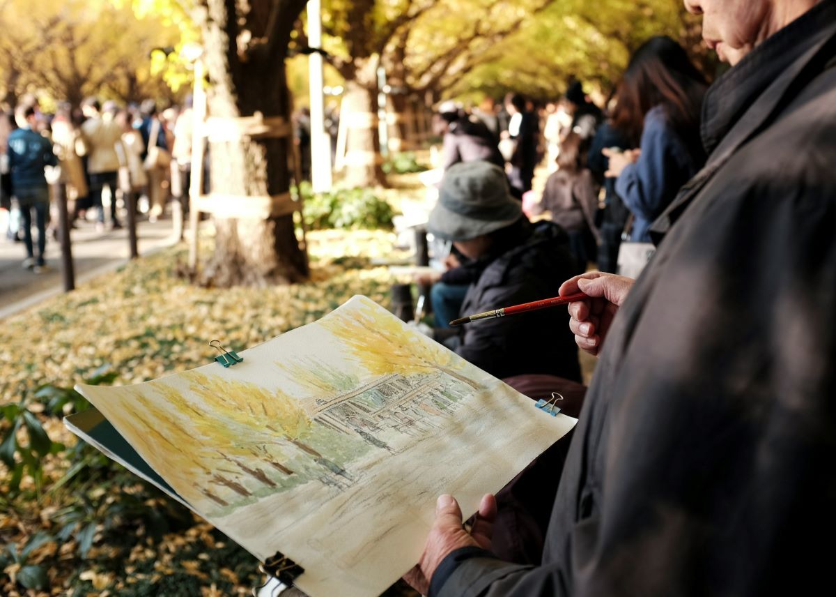 A man painting trees in fall in San Sebastian in November. 