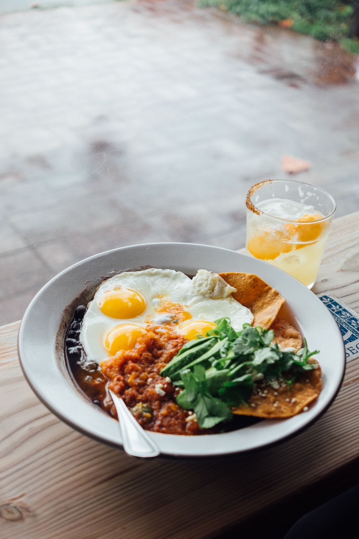 Overhead shot of huevos rancheros in a white bowl.