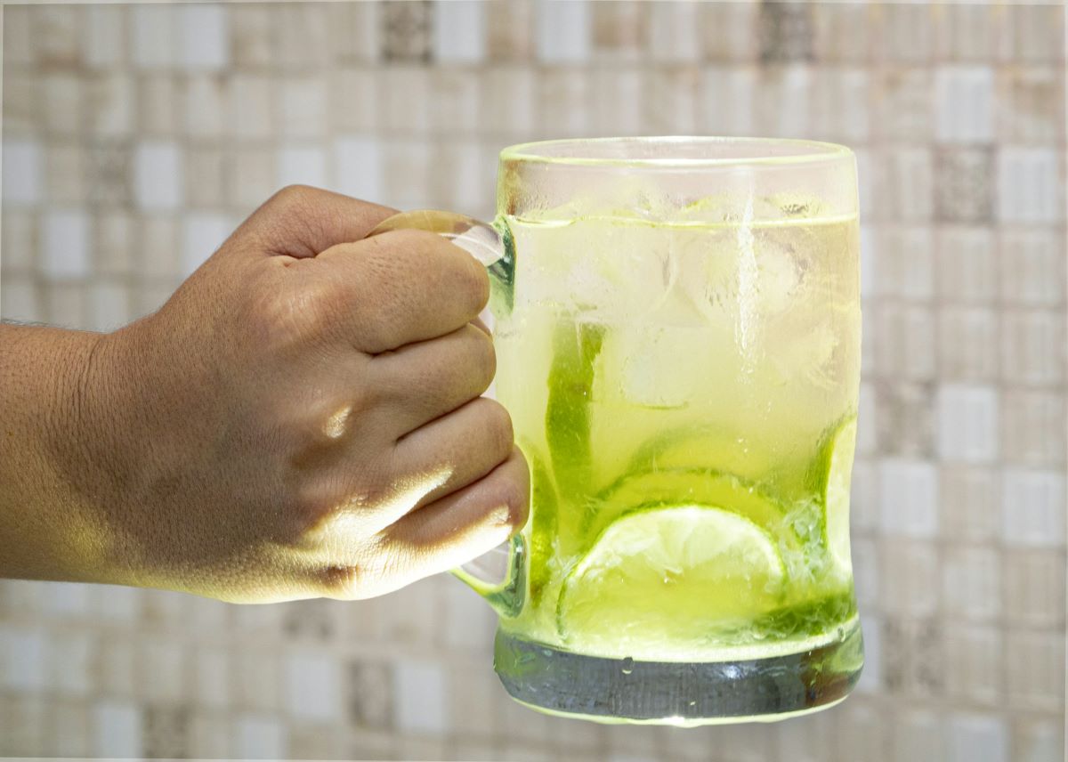 A man holding a large Caipirinha.