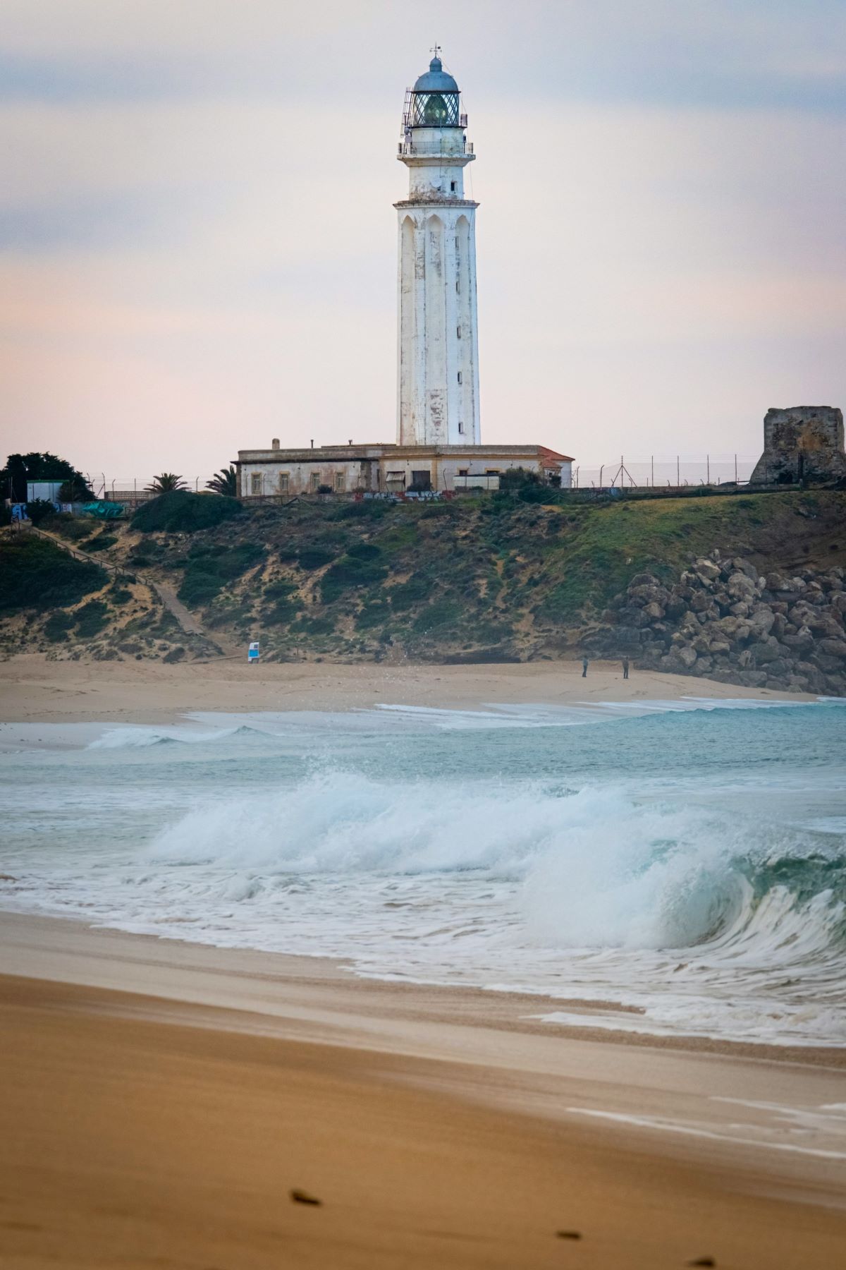 Waves crashing with the Trafalgar Lighthouse in the background. 