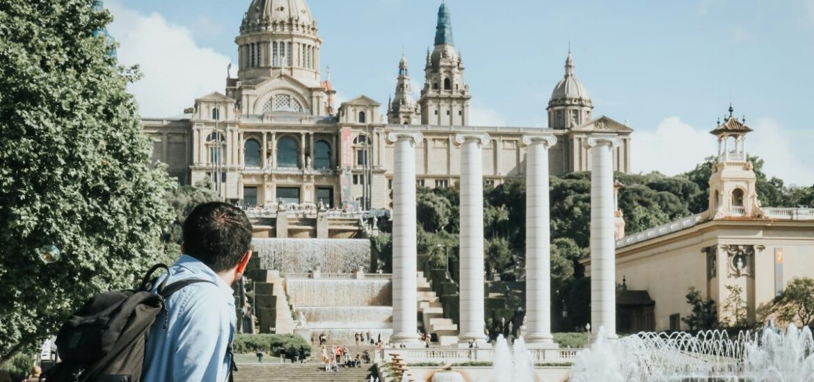 A man walking around and admiring the Museu Nacional d'Art de Catalunya (National Museum of Art of Catalonia)