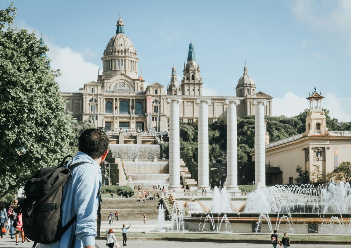 A man walking around and admiring the Museu Nacional d'Art de Catalunya (National Museum of Art of Catalonia)