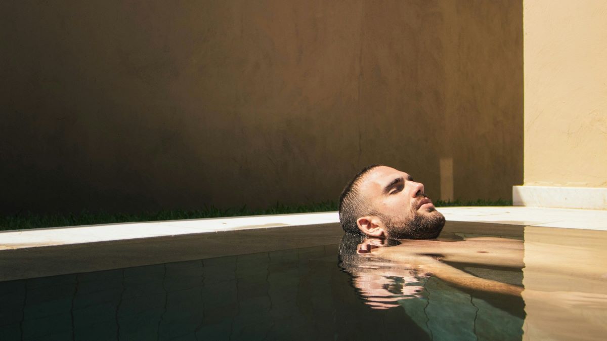 A man at a hammam in Sevilla relaxing in a thermal bath. 