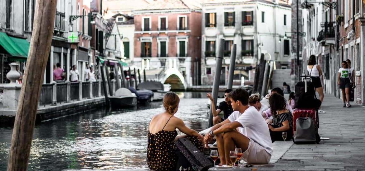 Enjoying cicchetti in Venice by a canal with drinks