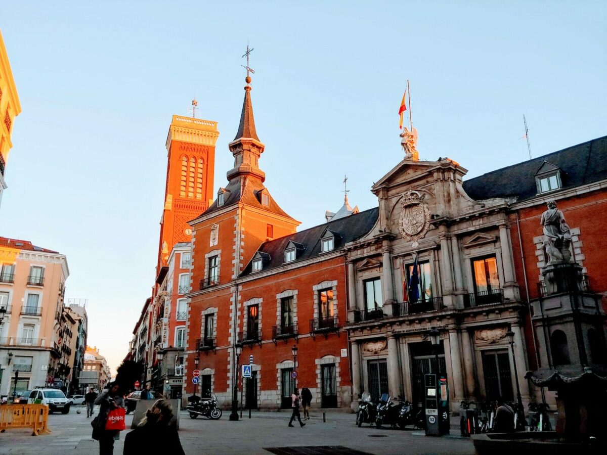 people walking near red building