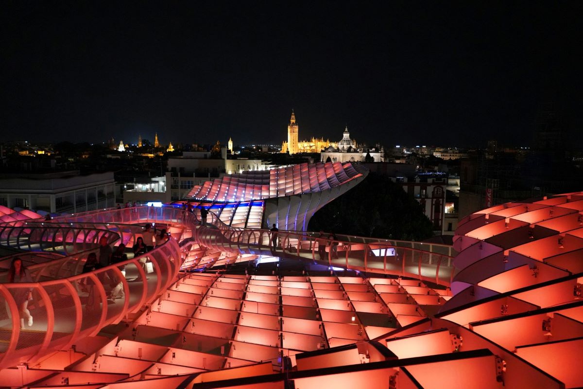 The rooftop of Setas in Seville illuminated at night. 