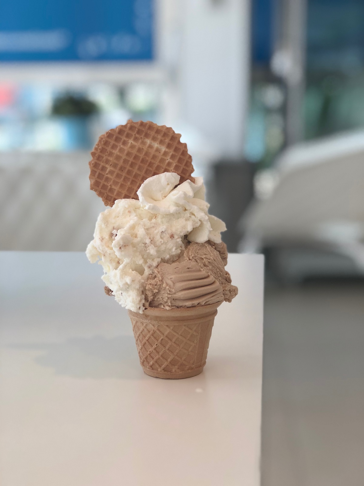 Gelato in a bologna gelateria with panna and a a cookie on top