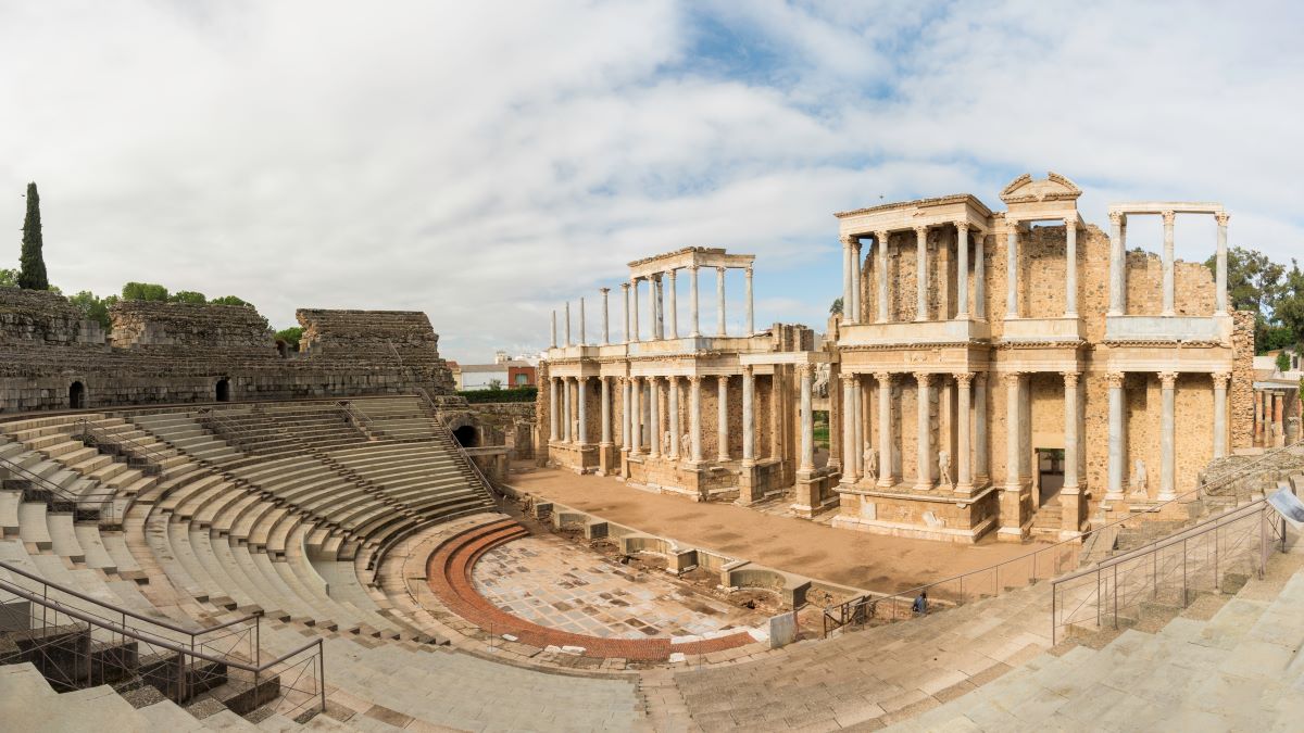 massive ampitheater surrounding a large stage with several roman columns