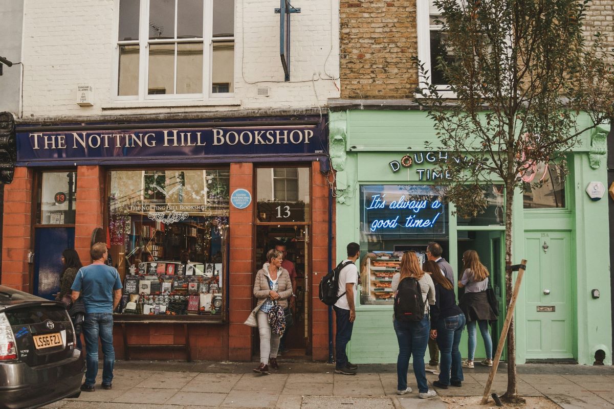 People waiting in a line outside of Doughnut Time in London. 