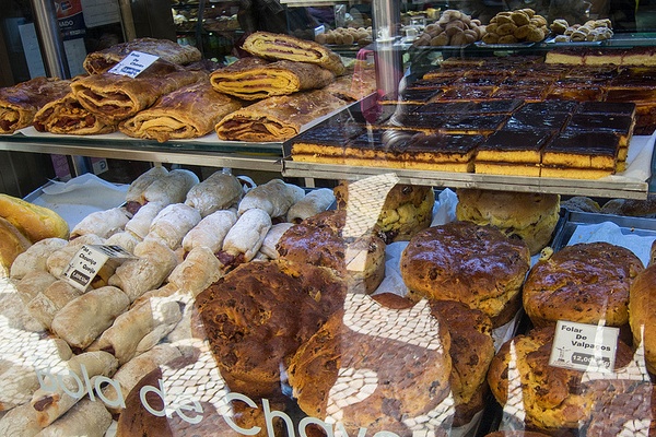 Pastries spread out in a pastelaria window: the only place to get pasteis de nata.