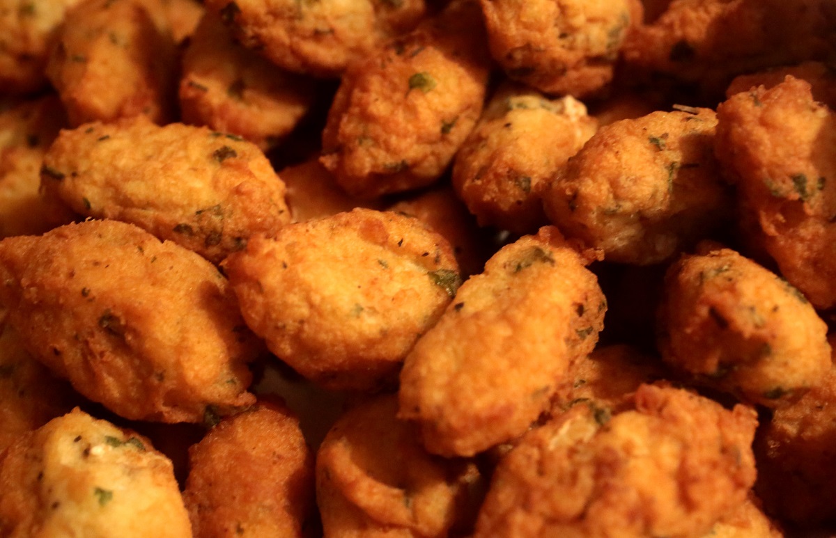 A tray of fried pastéis de bacalhau, codfish fritters from Portugal