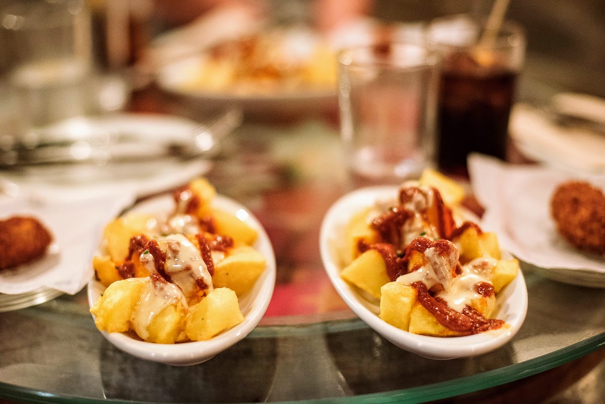 Fried potatoes with red spicy sauce and garlic mayonnaise