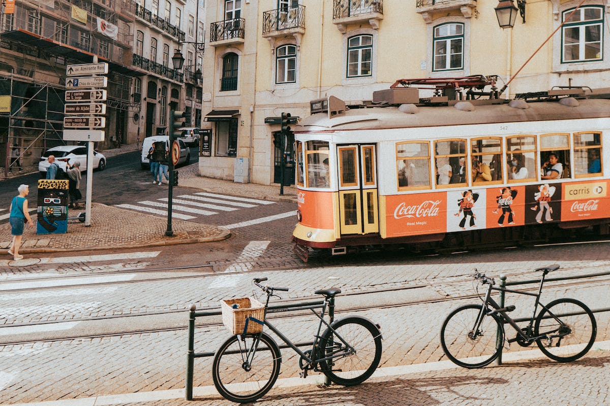 tram bairro alto with bikes and people walking