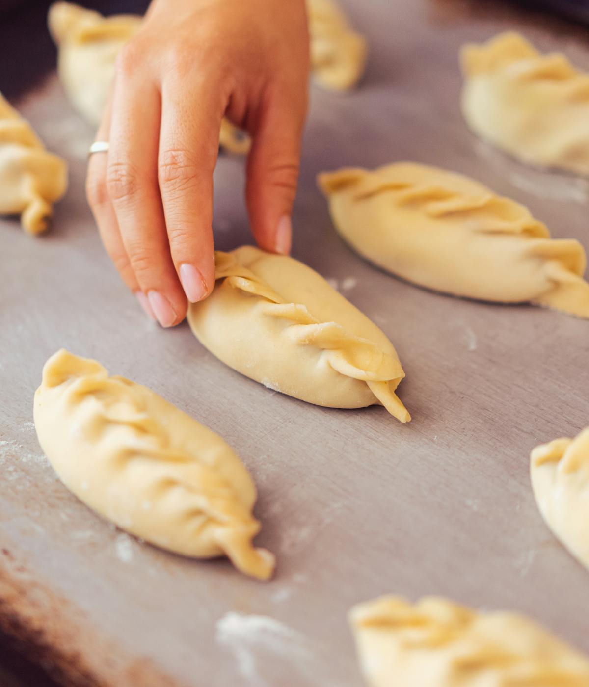 A woman making empanadas in NYC. 