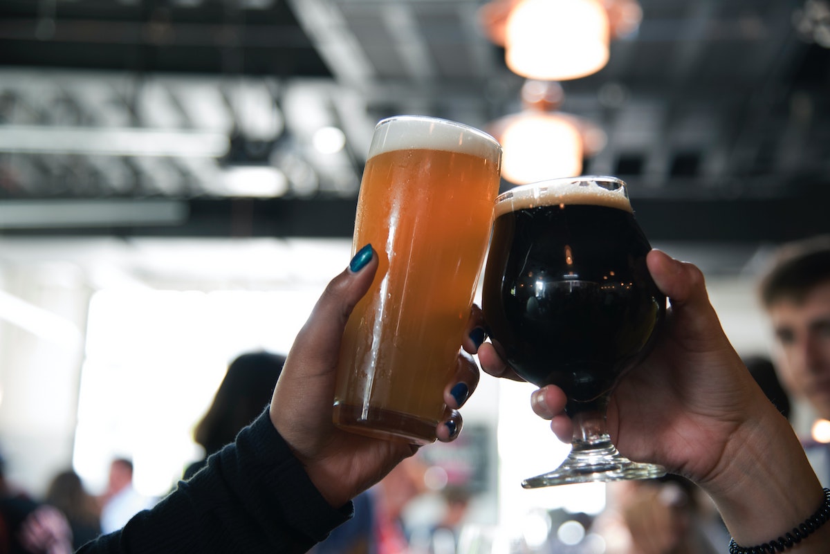 people toasting beers at a craft beer spot in Amsterdam.