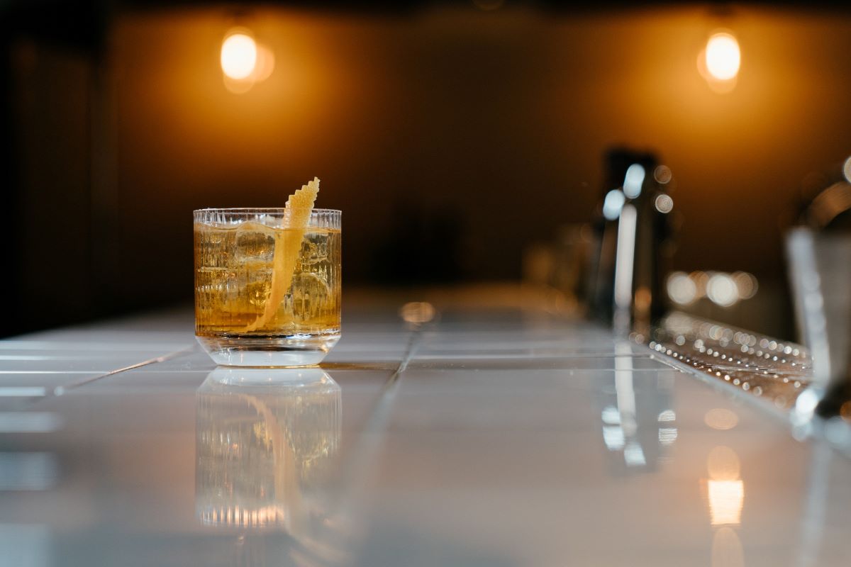 clear-drinking-glass-with-yellow-liquid-on-table