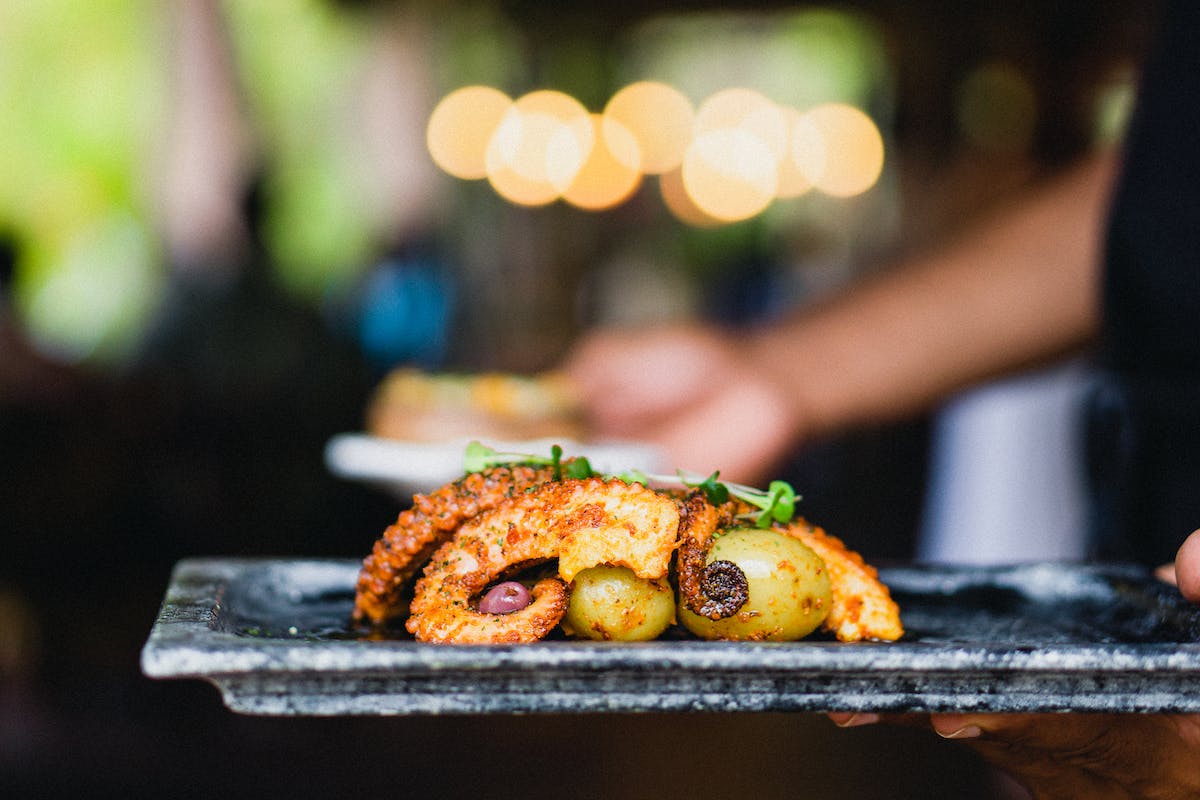 polvo a lagareiro octopus with potatoes on a tray