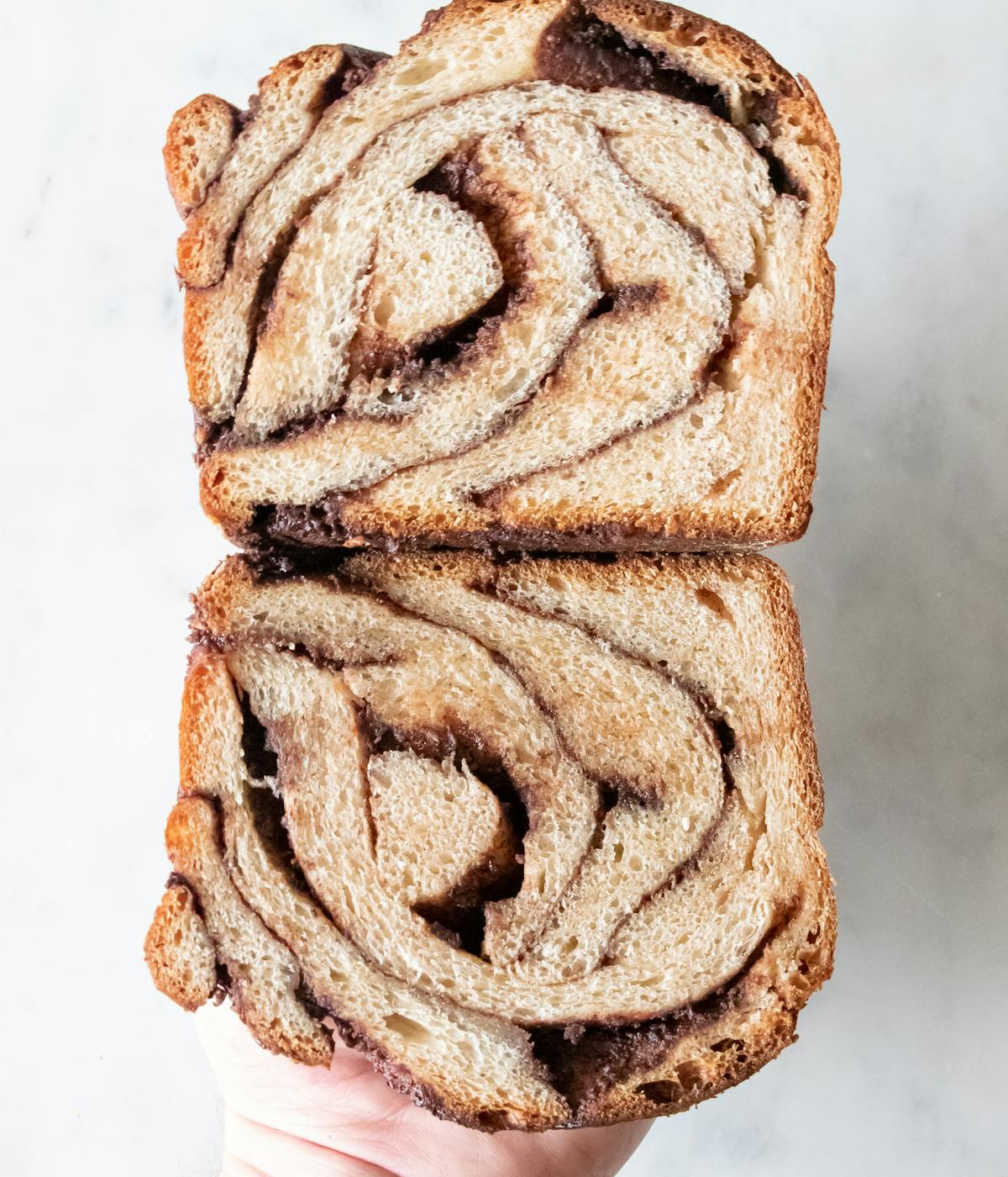 A person holding two slices of babka.