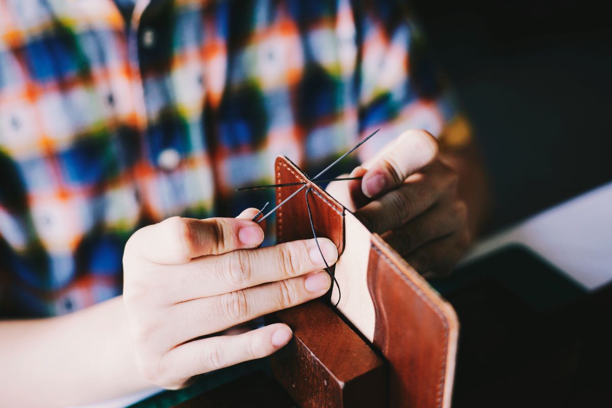 person-knitting-brown-leather-textile