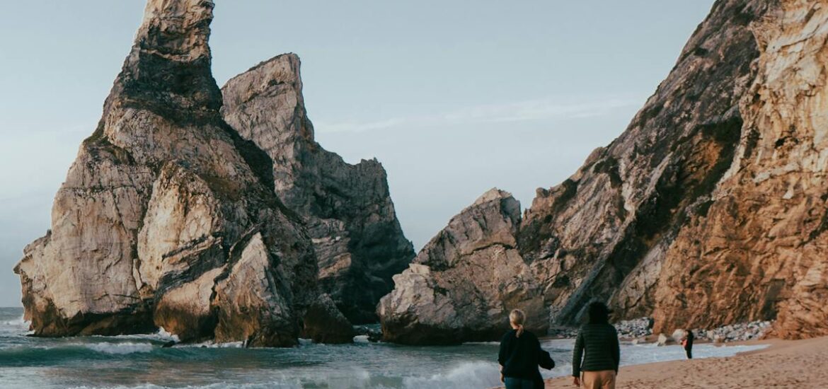 Two people walking on the beach on a day trip to Cabo da Roca.