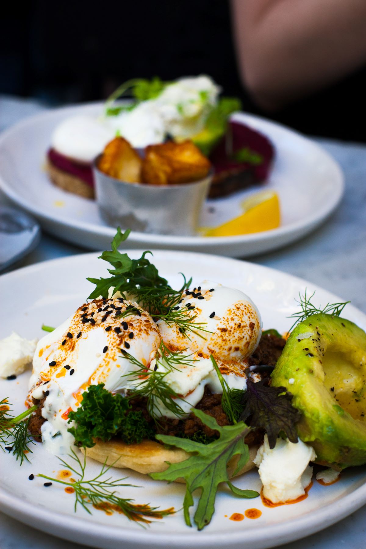 eggs over pancakes with avocado