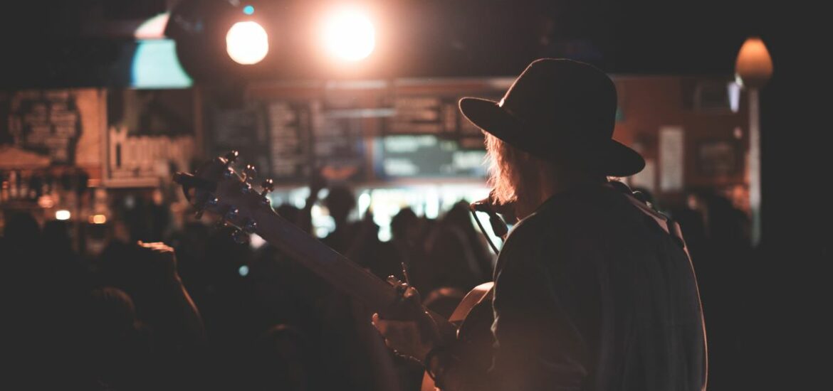 musician-playing-guitar-and-singing-at-concert