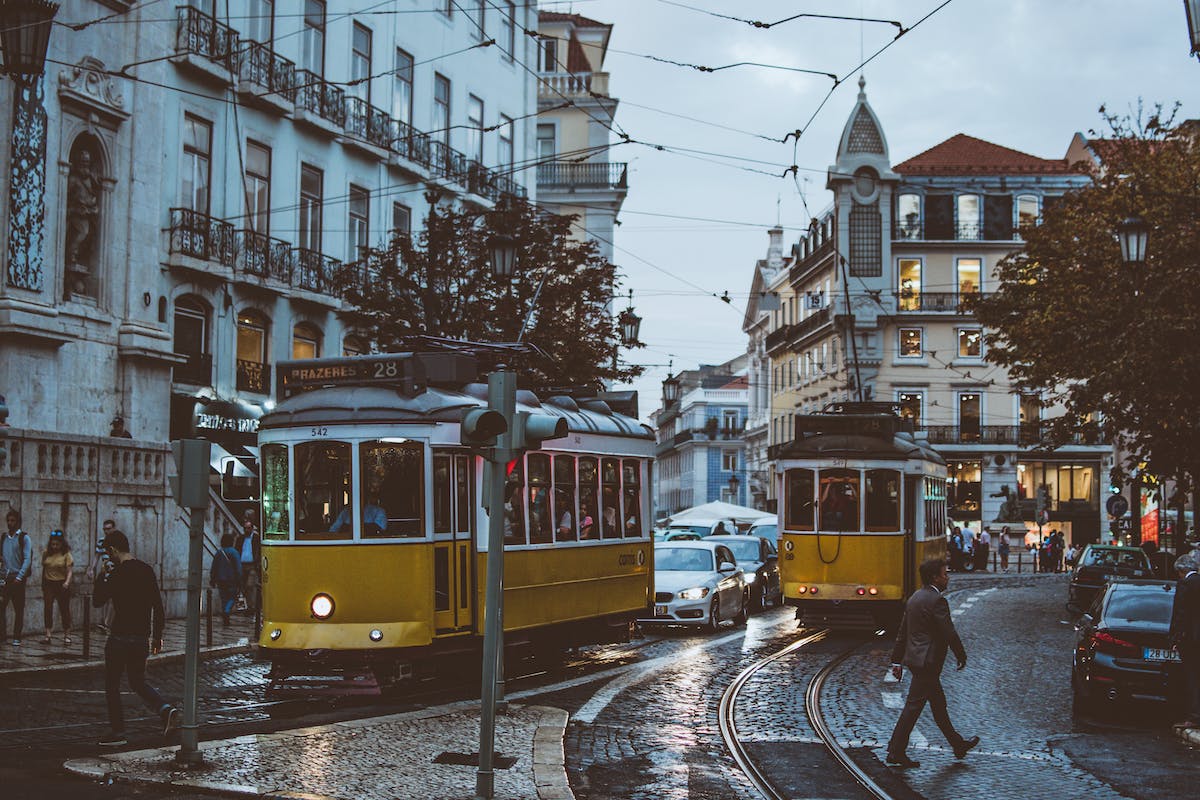 rainy day Lisbon tram people walking