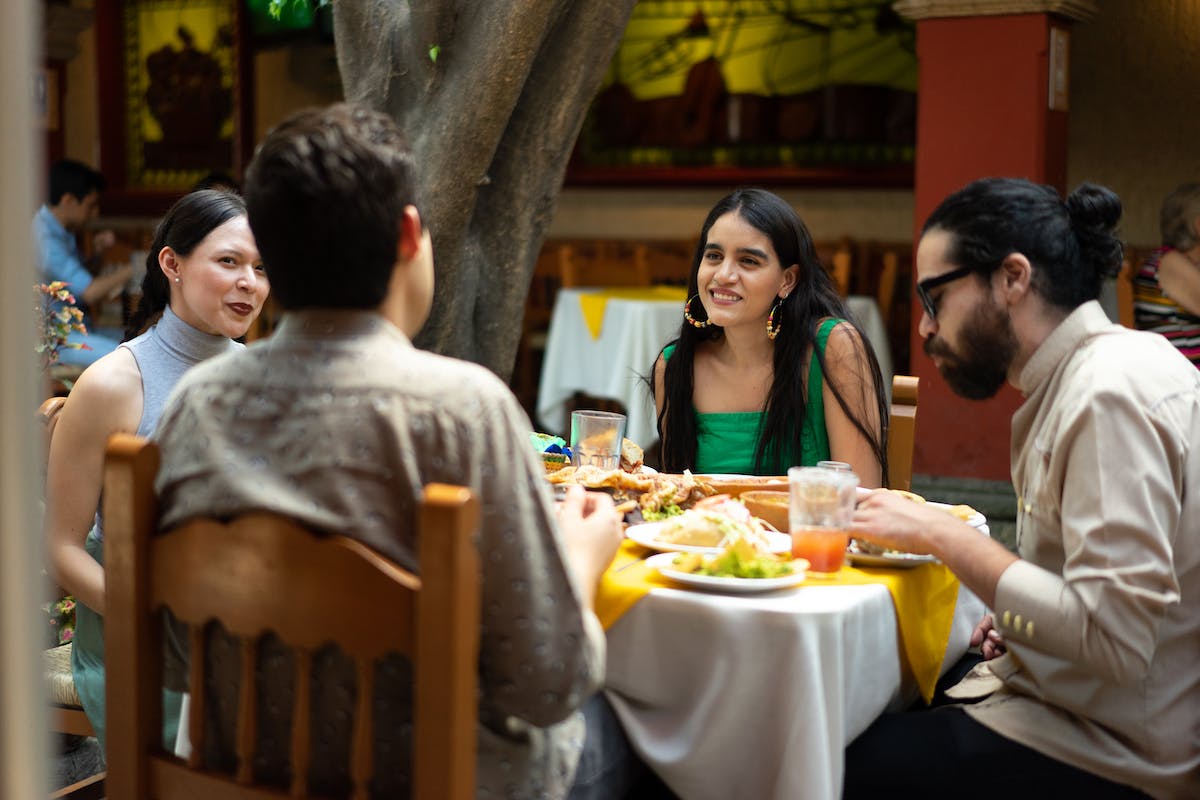 people eating petiscos friends sharing table afternoon