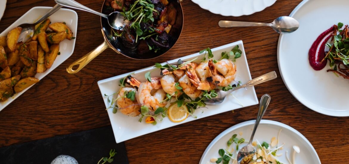 various plates of food on wooden table