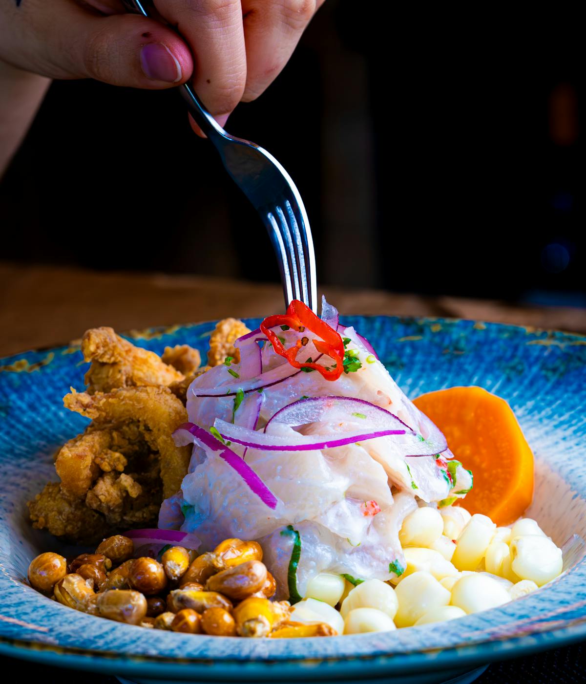 A woman eating ceviche at one of the best NYC Peruvian restaurants.