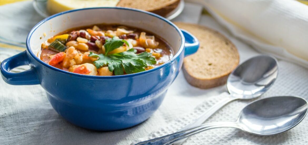 bowl of soup and two silver spoons