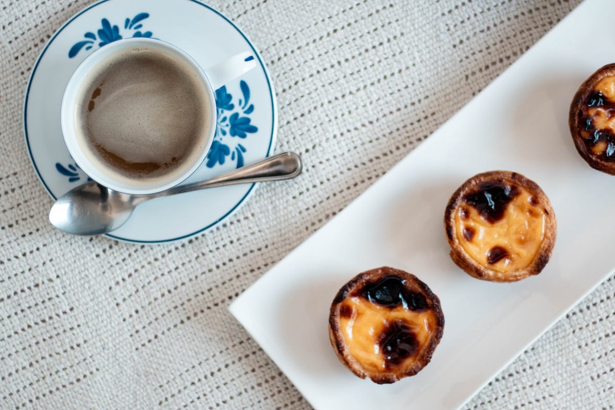 pasteis de nata and coffee on a saucer