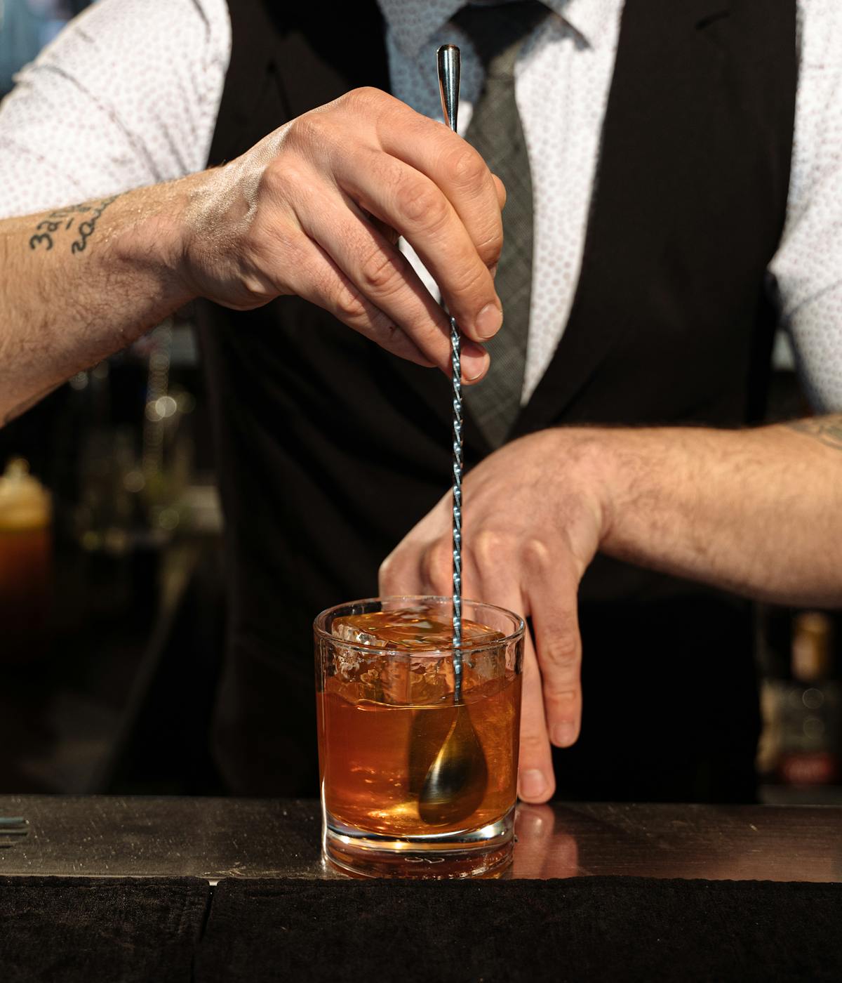 A bartender at a speakeasy making a special cocktail.