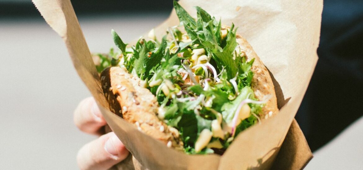 veggie burger with salad on top