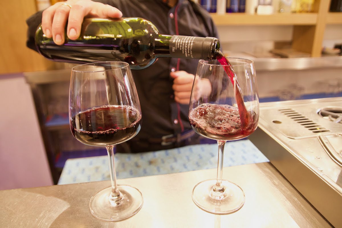 Two glasses of red wine being poured