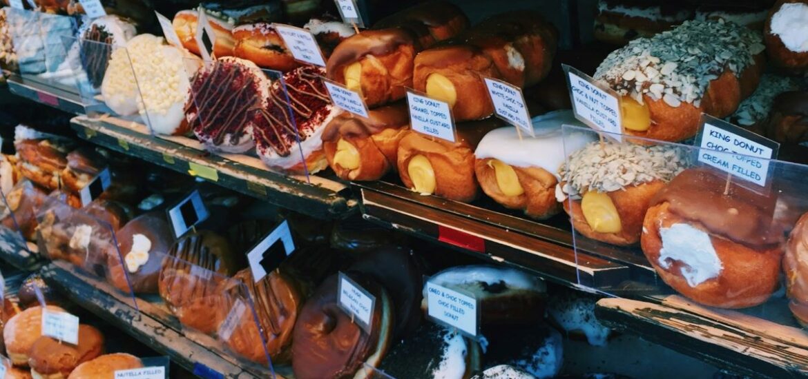 Rows of artisanal doughnuts in a London doughnut shop.