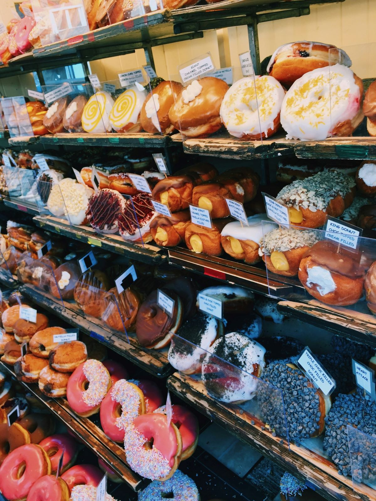 Rows of artisanal doughnuts in a London doughnut shop.
