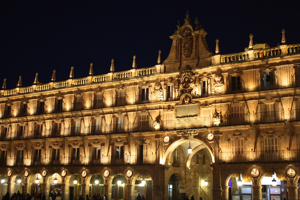 Façade of brightly lit historic building at night.
