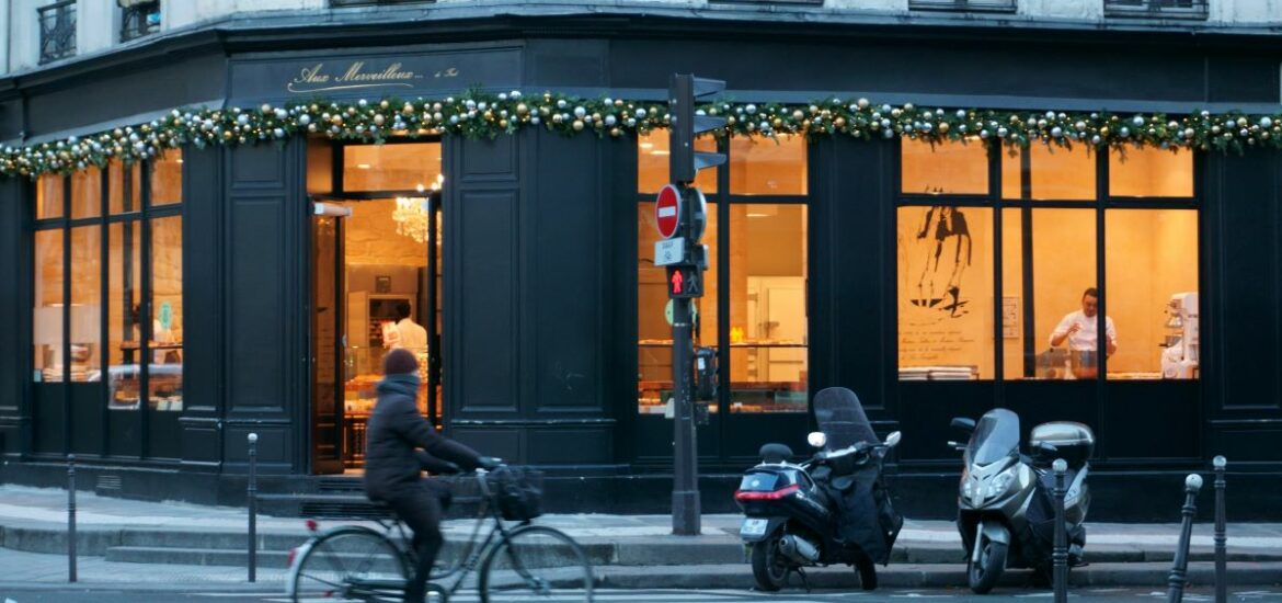 a person cycling past a shop