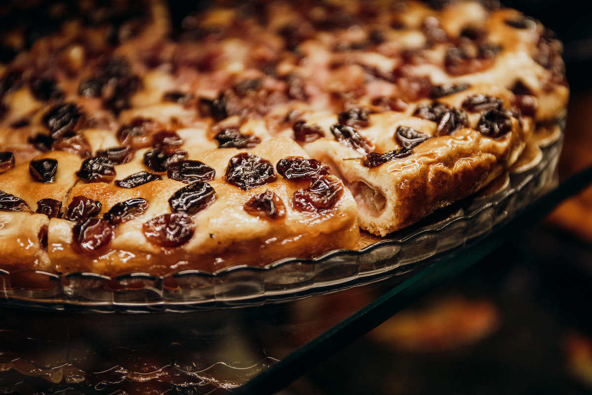 Close up of Tuscan style focaccia topped with roasted cherry tomatoes