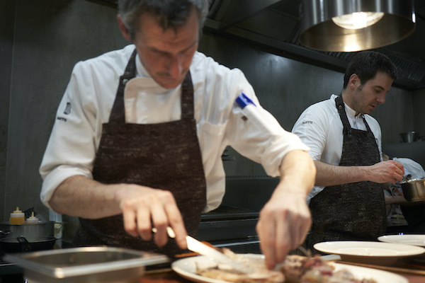 Kitchen team at Narru restaurant preparing seafood dishes